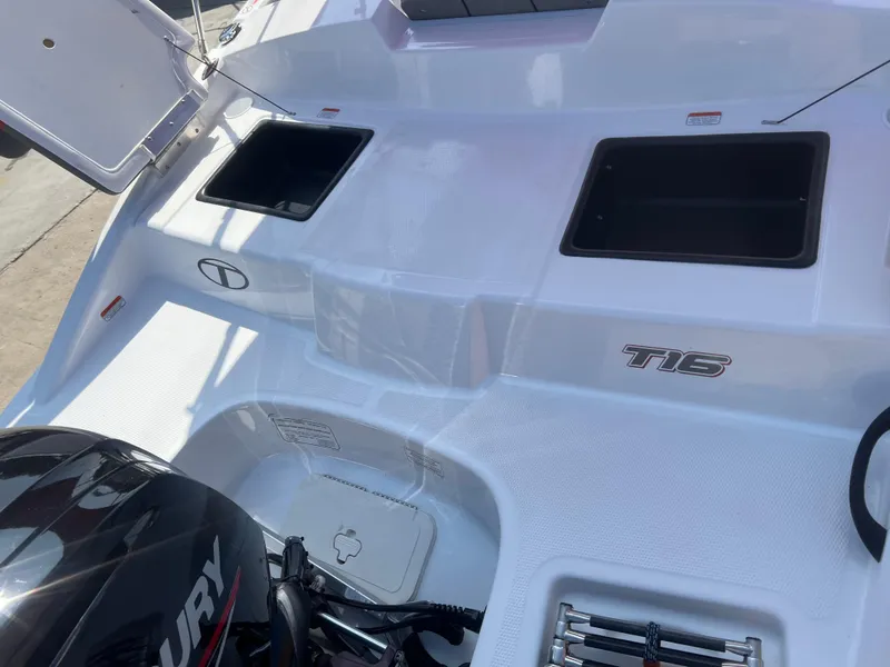 Slide: The Image of 2022 Tahoe T16 boat deck with Mercury engine and storage compartments. - 15