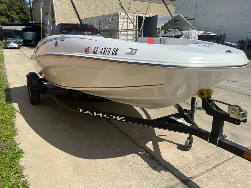 Slide: The Image of 2022 Tahoe T16 boat on trailer, parked outdoors in sunny weather. - 2