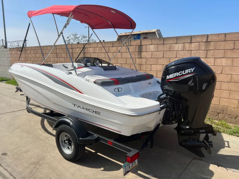 Slide: The Image of 2022 Tahoe T16 boat with red canopy and Mercury outboard motor on trailer. - 3