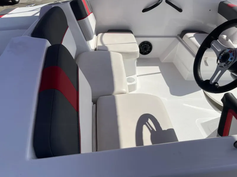Slide: The Image of 2022 Tahoe T16 boat interior with white and black seating, red accents, and steering wheel. - 4