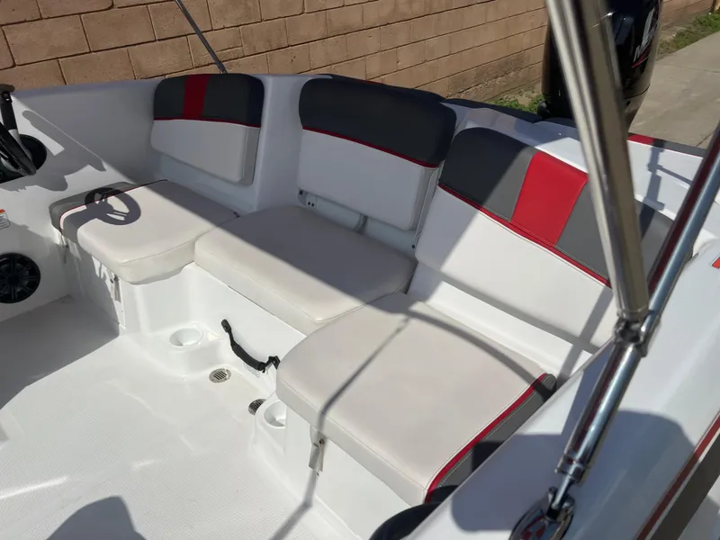 Slide: The Image of 2022 Tahoe T16 boat interior with white and red seating, steering wheel, and speakers. - 9
