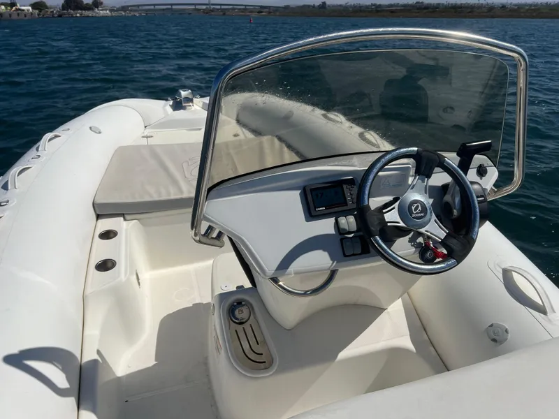 Slide: The Image of 2020 Zodiac N-ZO 600 boat interior with steering wheel and seating on open water. - 11