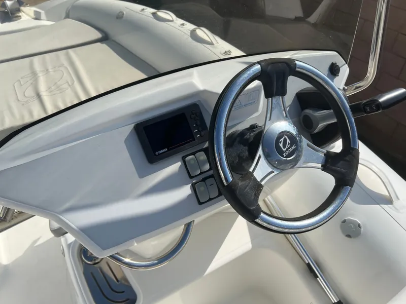 Slide: The Image of 2020 Zodiac N-ZO 600 boat dashboard with steering wheel and control panel. - 18