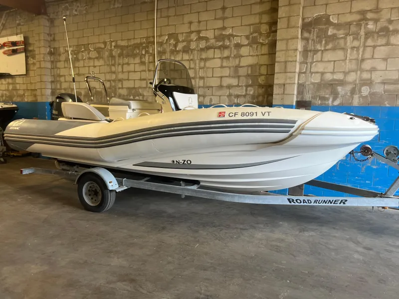 Slide: The Image of 2020 Zodiac N-ZO 600 boat on trailer in garage setting. - 23