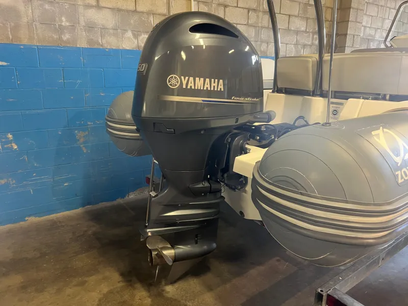 Slide: The Image of 2020 Zodiac N-ZO 600 boat with Yamaha outboard motor in a garage setting. - 25