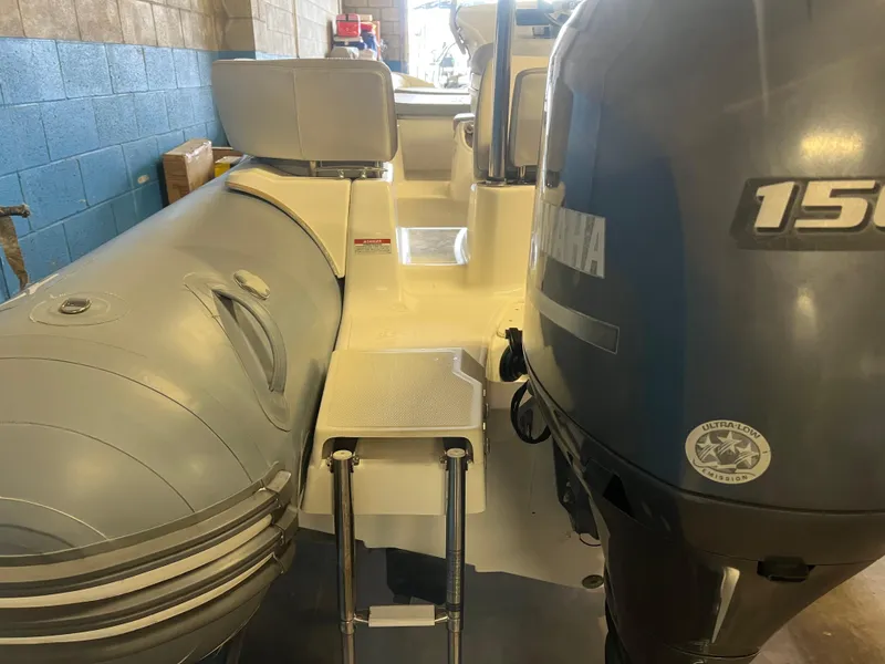 Slide: The Image of 2020 Zodiac N-ZO 600 boat with Yamaha 150 engine in a garage setting. - 26