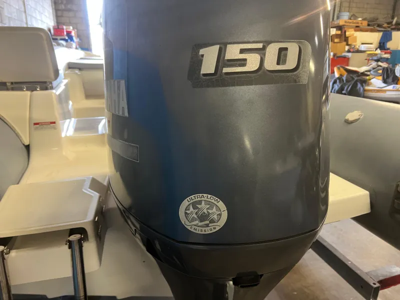 Slide: The Image of Yamaha 150 outboard motor on 2020 Zodiac N-ZO 600 boat in a garage setting. - 27