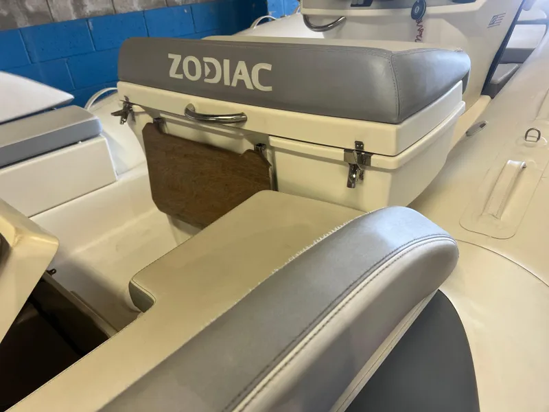 Slide: The Image of 2020 Zodiac N-ZO 600 boat interior with gray seating and storage compartment. - 28