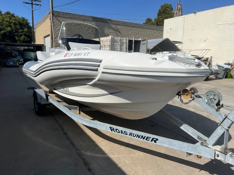 Slide: The Image of 2020 Zodiac N-ZO 600 boat on Road Runner trailer in outdoor setting. - 5