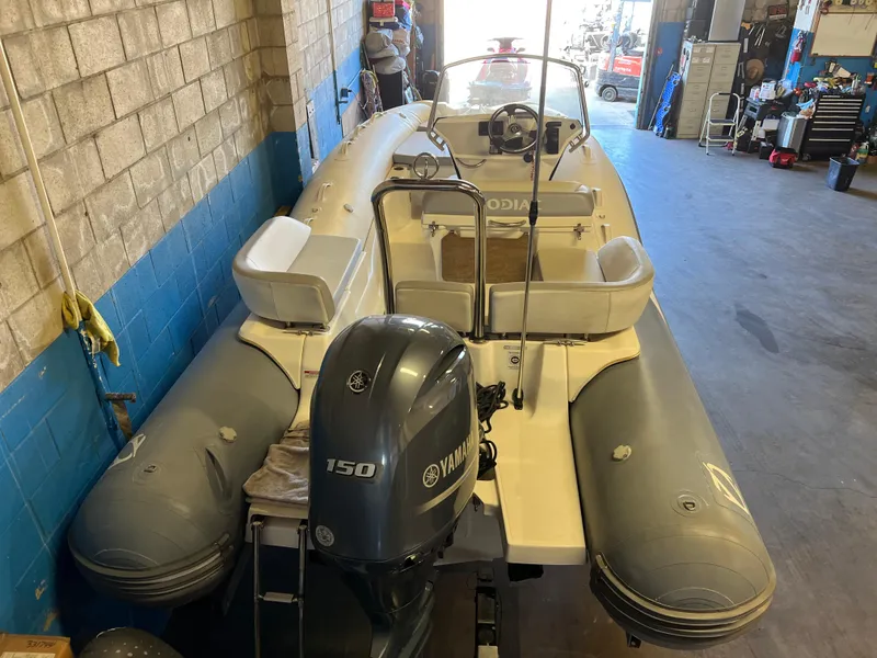 Slide: The Image of 2020 Zodiac N-ZO 600 boat with Yamaha 150 engine in a workshop setting. - 7