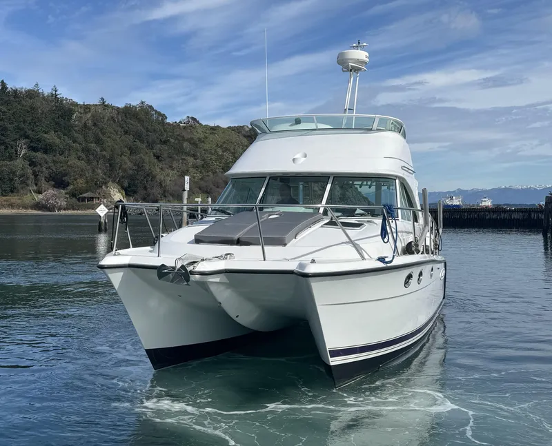 Slide: The Image of 2005 Glacier Bay 3490 Ocean Runner catamaran on calm water, scenic background. - 1