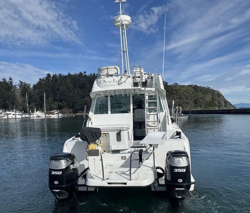 Slide: The Image of 2005 Glacier Bay 3490 Ocean Runner boat with dual 350 engines on calm water. - 10