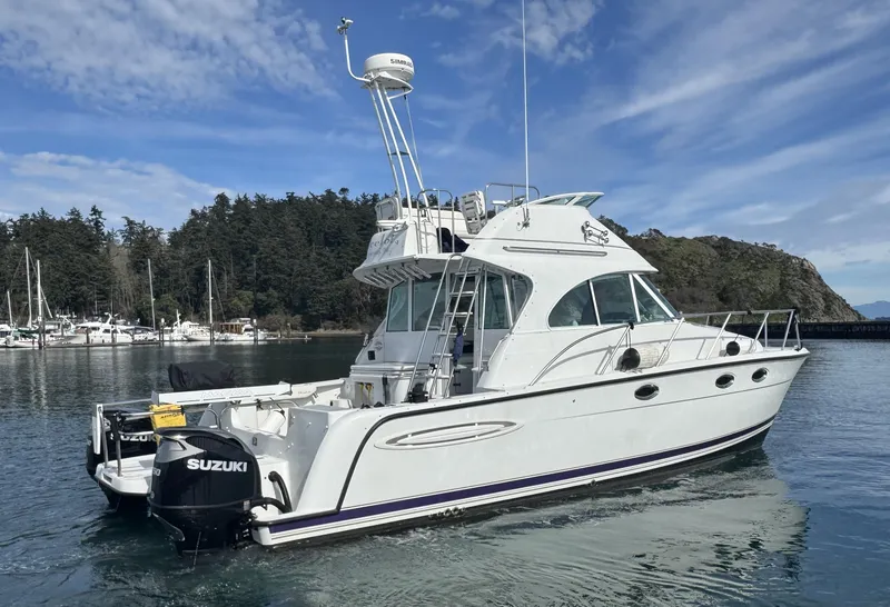 Slide: The Image of 2005 Glacier Bay 3490 Ocean Runner boat on calm water with Suzuki engines. - 12