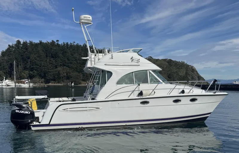 Slide: The Image of 2005 Glacier Bay 3490 Ocean Runner boat on calm water, side view. - 13