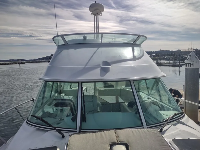 Slide: The Image of 2005 Glacier Bay 3490 Ocean Runner boat docked at marina under cloudy sky. - 16
