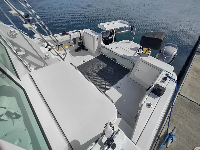 Slide: The Image of 2005 Glacier Bay 3490 Ocean Runner boat docked, showcasing spacious deck and seating area. - 20