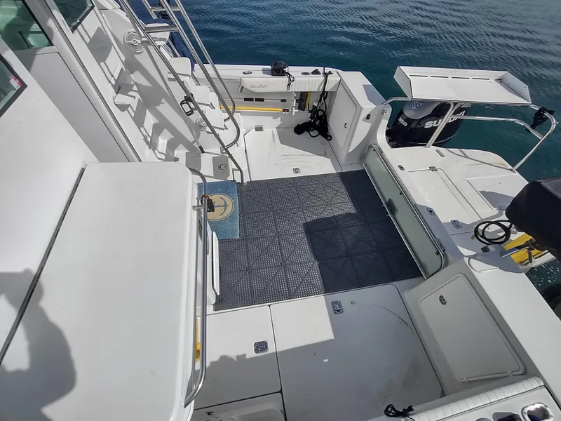 Slide: The Image of 2005 Glacier Bay 3490 Ocean Runner boat deck with seating and equipment, overlooking calm water. - 21