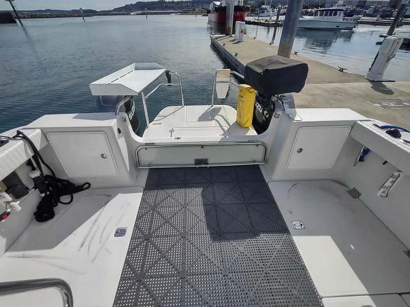 Slide: The Image of 2005 Glacier Bay 3490 Ocean Runner boat docked at marina, featuring spacious deck area. - 26