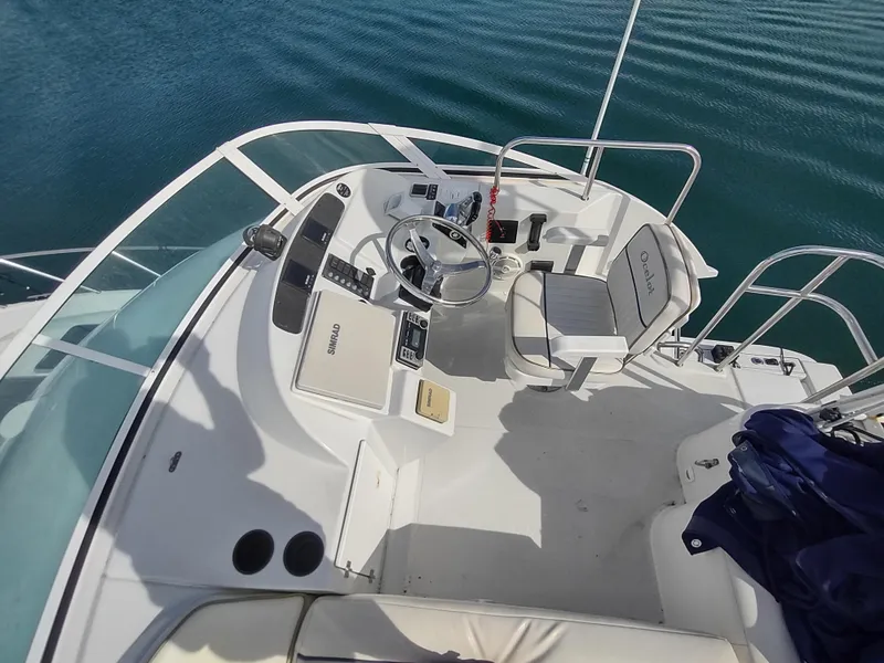 Slide: The Image of 2005 Glacier Bay 3490 Ocean Runner boat helm with steering wheel and controls. - 28