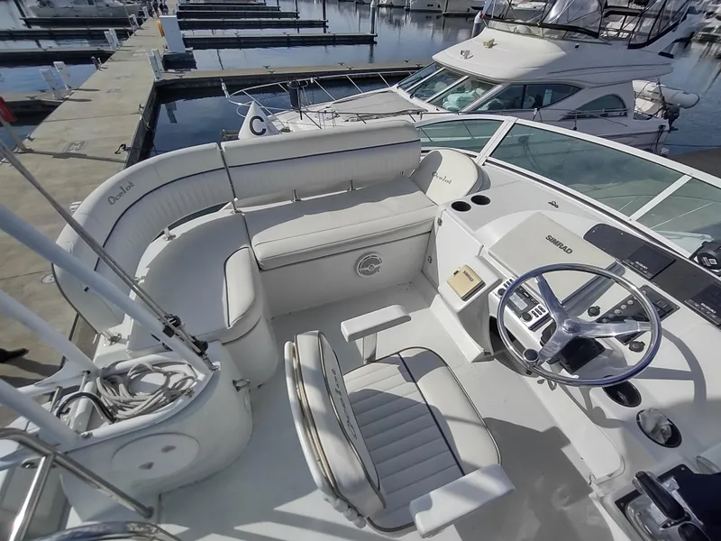 Slide: The Image of 2005 Glacier Bay 3490 Ocean Runner boat interior with seating and steering wheel at marina. - 29