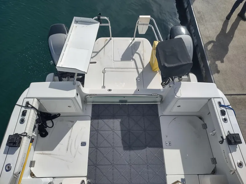 Slide: The Image of 2005 Glacier Bay 3490 Ocean Runner boat docked, showing spacious deck and dual engines. - 31