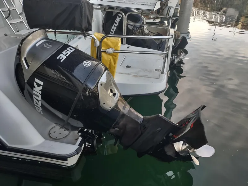 Slide: The Image of Outboard motor on 2005 Glacier Bay 3490 Ocean Runner, docked in calm waters. - 38