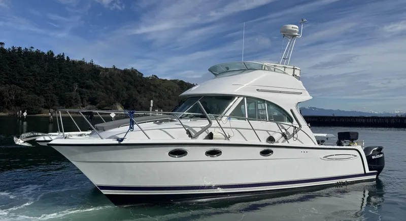 Slide: The Image of 2005 Glacier Bay 3490 Ocean Runner boat on calm water, clear sky background. - 4