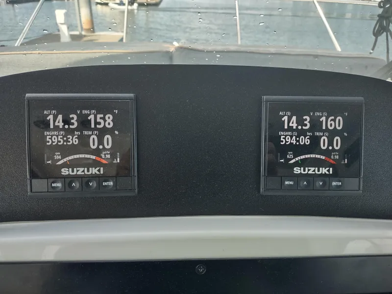 Slide: The Image of Dashboard of 2005 Glacier Bay 3490 Ocean Runner with Suzuki engine displays. - 49