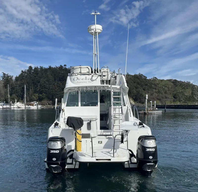 Slide: The Image of 2005 Glacier Bay 3490 Ocean Runner boat on water, twin 350 engines, scenic background. - 9