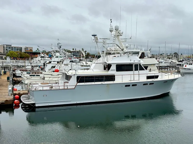 The Image of 1967 Elliott Yachtfisher docked in a marina, overcast sky, calm water. - 0