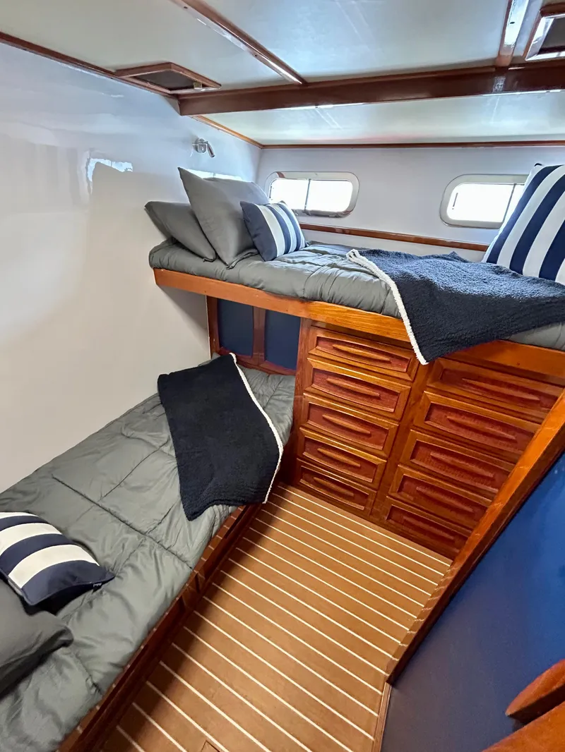Slide: The Image of 1967 Elliott Yachtfisher cabin with wooden interior, bunk beds, and nautical-themed decor. - 10