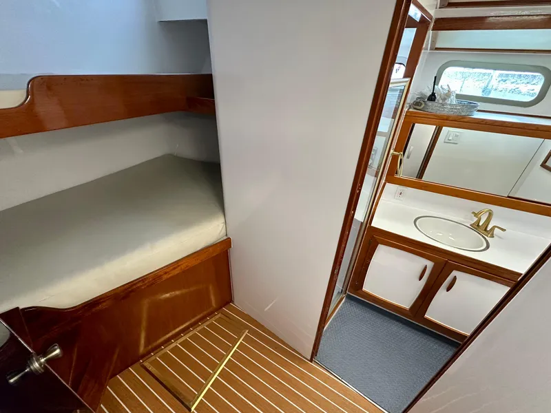 Slide: The Image of Interior of 1967 Elliott Yachtfisher showing cozy cabin and bathroom with wooden accents. - 11