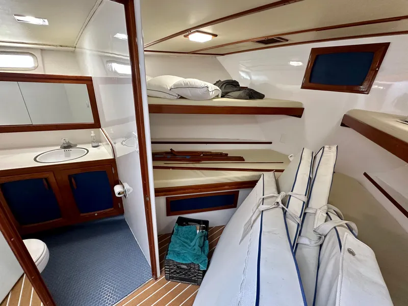 Slide: The Image of 1967 Elliott Yachtfisher interior with bunks, bathroom, and wooden accents. - 12