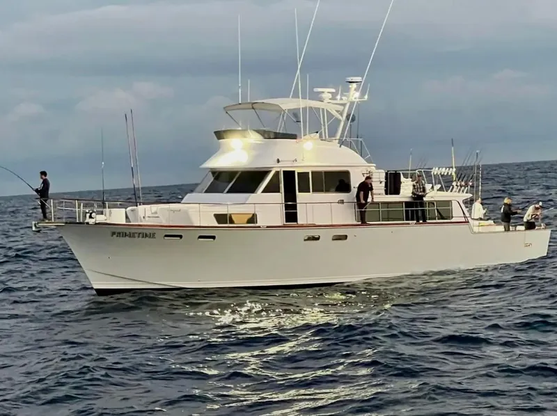 Slide: The Image of 1967 Elliott Yachtfisher on open sea with people fishing, under cloudy sky. - 15