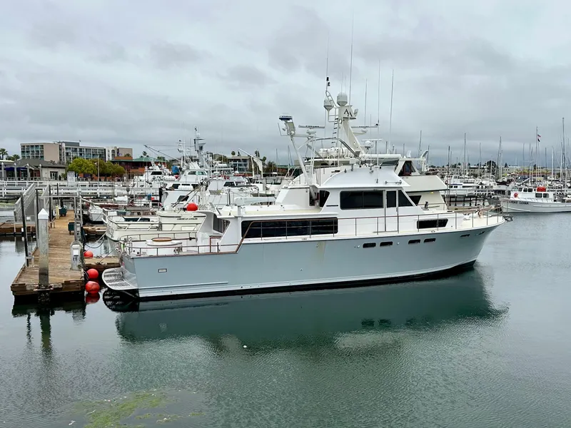 Slide: The Image of 1967 Elliott Yachtfisher docked in a marina under cloudy skies. - 16