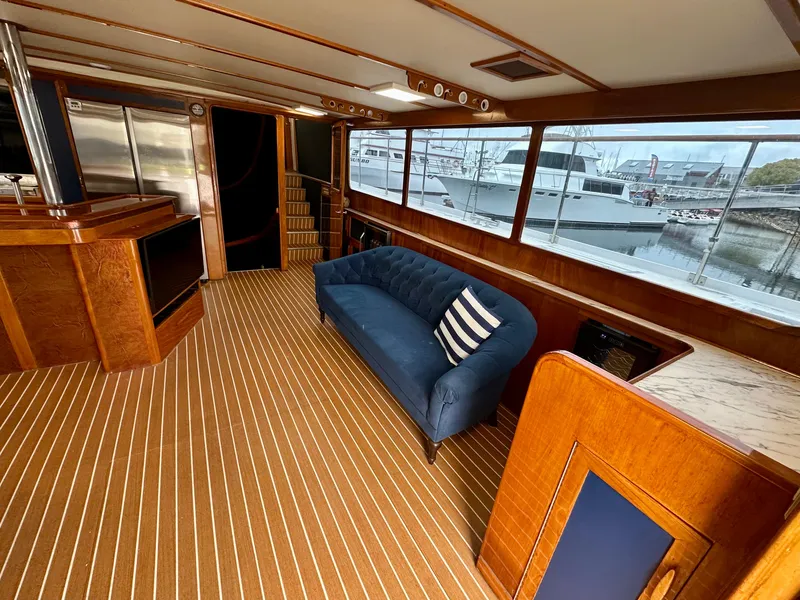 Slide: The Image of Interior of 1967 Elliott Yachtfisher with blue sofa, striped carpet, and large windows. - 3