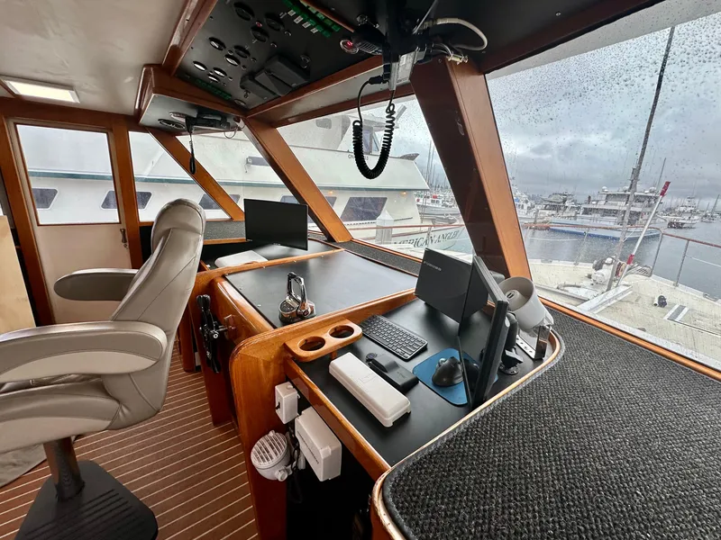 Slide: The Image of Interior of a 1967 Elliott Yachtfisher, featuring a helm with modern navigation equipment. - 4