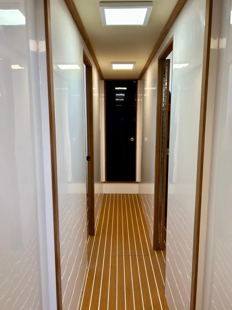 Slide: The Image of Interior hallway of a 1967 Elliott Yachtfisher, featuring wood paneling and modern lighting. - 6