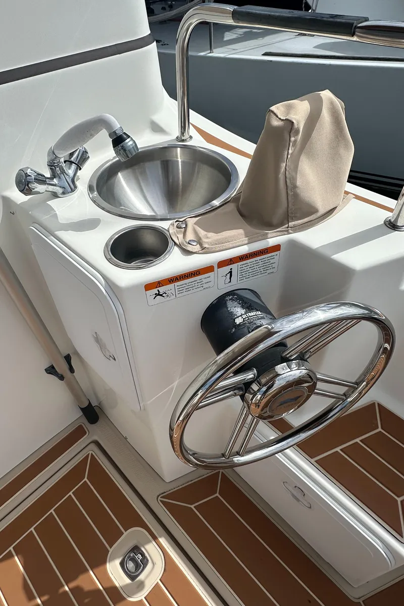 Slide: The Image of 2016 Cutwater 28 boat helm with stainless steel sink and steering wheel. - 12