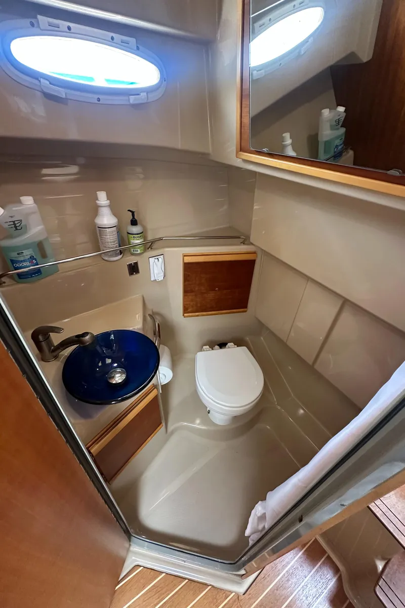 Slide: The Image of 2016 Cutwater 28 boat bathroom with sink, toilet, and storage. - 17