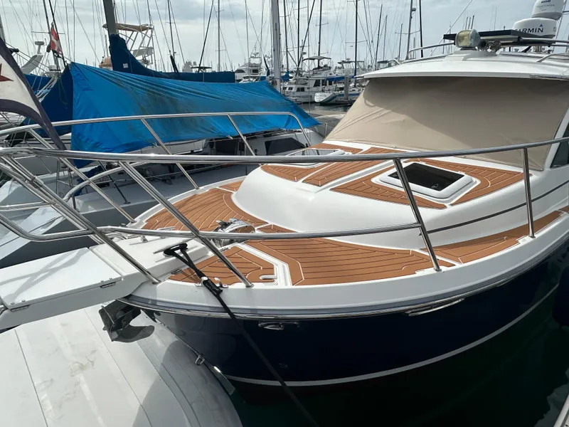 Slide: The Image of 2016 Cutwater 28 boat with teak deck, docked at marina. - 2