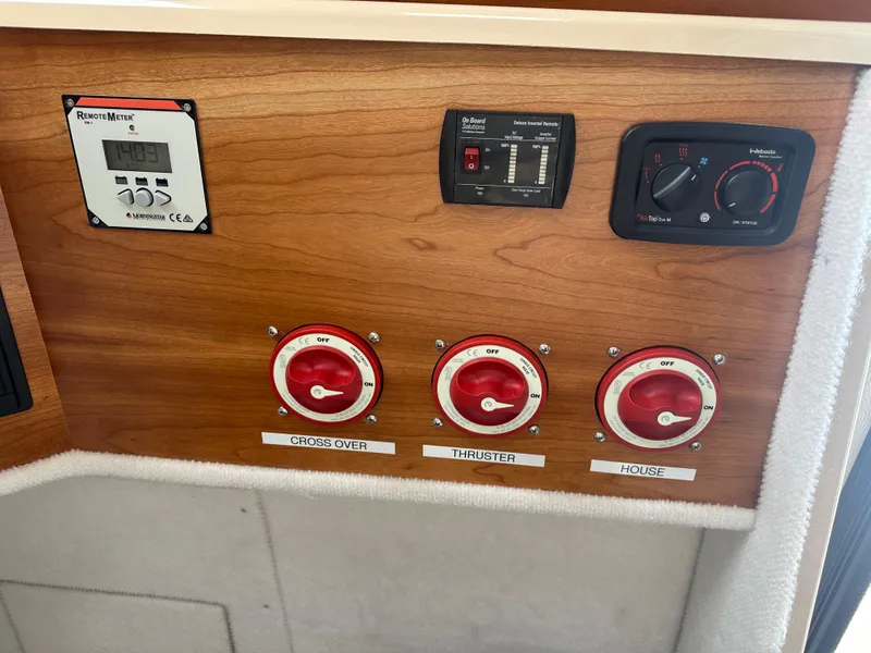 Slide: The Image of Control panel of a 2016 Cutwater 28 boat with labeled switches and meters. - 21