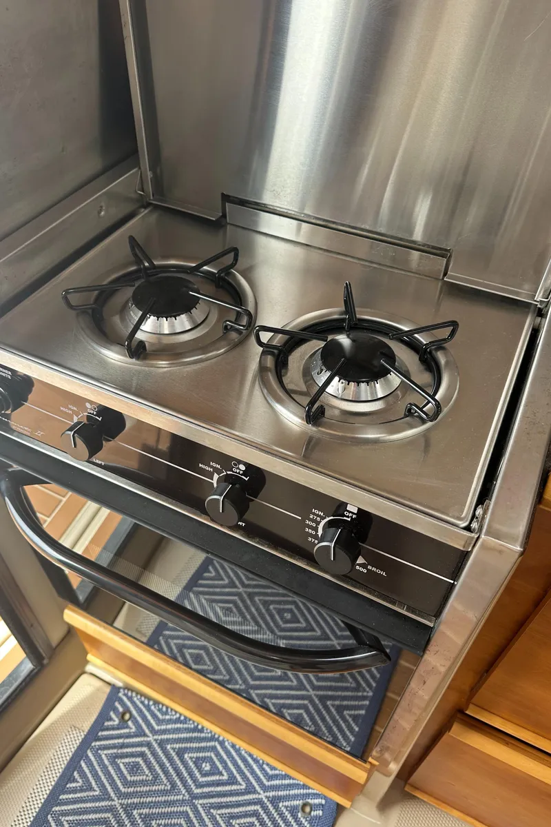 Slide: The Image of Stainless steel two-burner stove in a 2016 Cutwater 28 boat kitchen. - 22