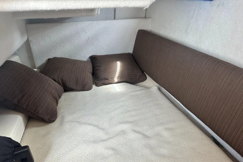 Slide: The Image of Cozy interior cabin of 2016 Cutwater 28 boat with brown cushions. - 23