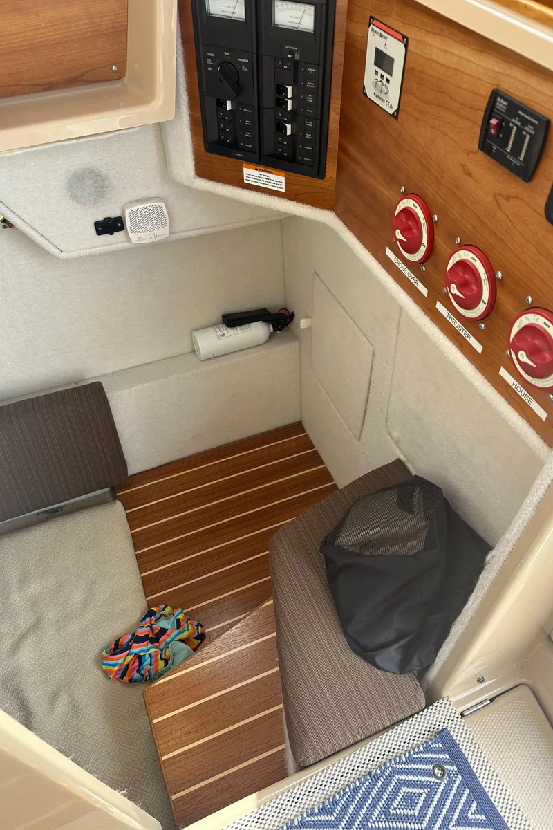Slide: The Image of 2016 Cutwater 28 cabin interior with control panels and seating area. - 24