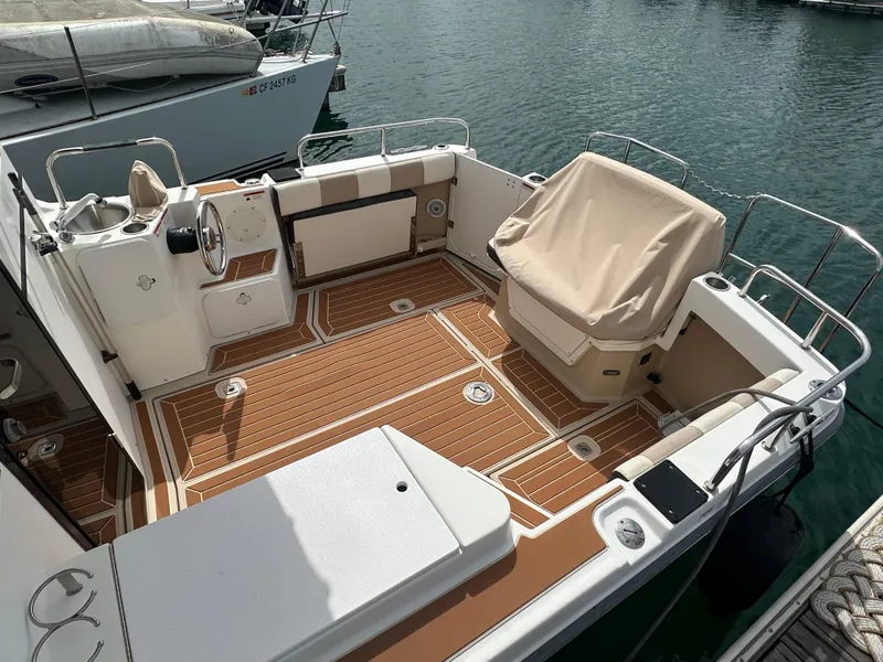 Slide: The Image of 2016 Cutwater 28 boat with spacious deck and covered seating, docked at marina. - 5