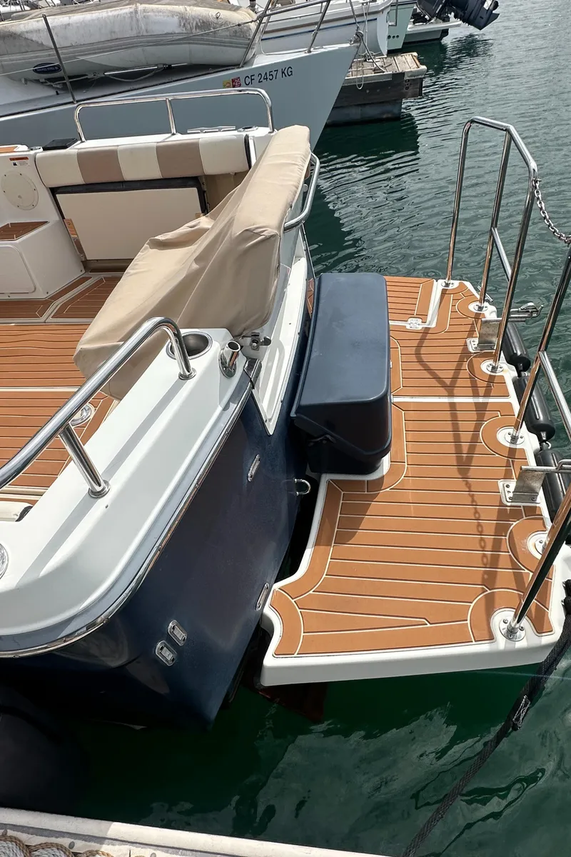 Slide: The Image of 2016 Cutwater 28 boat with teak deck and swim platform in marina. - 6