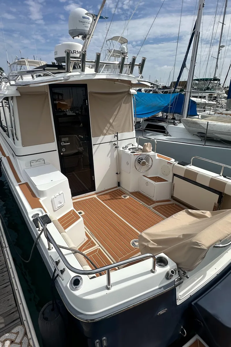 Slide: The Image of 2016 Cutwater 28 boat with spacious deck, docked at marina. - 7