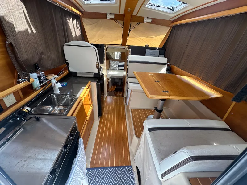 Slide: The Image of Interior of a 2016 Cutwater 28 boat with kitchen and dining area. - 8