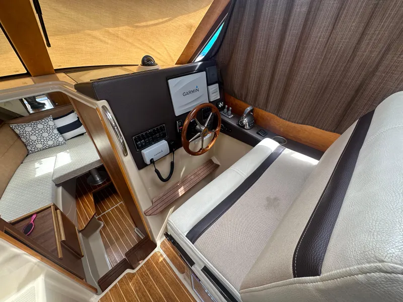 Slide: The Image of Interior of 2016 Cutwater 28 boat with steering wheel and navigation equipment. - 9